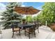 Outdoor patio with an umbrella, chairs, and greenery for outdoor entertaining at 6296 W Prentice Ave, Littleton, CO 80123