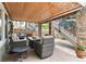 Relaxing covered patio with comfortable seating and stone columns, perfect for outdoor entertaining at 6296 W Prentice Ave, Littleton, CO 80123