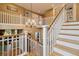 Elegant staircase with wood and white railings, leading to the upper level at 6296 W Prentice Ave, Littleton, CO 80123