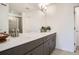Modern bathroom featuring double sinks, a large mirror, and a tiled shower at 370 Geneva St, Aurora, CO 80010