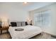 Bright bedroom with a comfortable bed, bedside tables and modern lamps at 370 Geneva St, Aurora, CO 80010