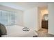Bright bedroom with soft carpet, a comfortable bed, and dark wood drawers at 370 Geneva St, Aurora, CO 80010
