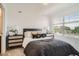 Bright bedroom with a large window, stylish nightstands, and comfortable bedding at 370 Geneva St, Aurora, CO 80010