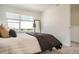 Cozy bedroom with a large window, a full-length mirror, and neutral tones at 370 Geneva St, Aurora, CO 80010
