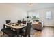 Dining area with modern table setting, elegant chairs, and a view into the living space at 370 Geneva St, Aurora, CO 80010