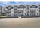 Modern townhome complex with brick facade, white accents, and individual entryways at 370 Geneva St, Aurora, CO 80010