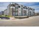 View of modern townhomes showing brick, balconies, and contemporary design at 370 Geneva St, Aurora, CO 80010