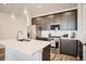 Modern kitchen with pendant lights, stainless steel appliances, and white countertops at 370 Geneva St, Aurora, CO 80010