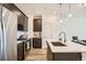 Modern kitchen featuring stainless steel appliances, an island, and sleek cabinets at 370 Geneva St, Aurora, CO 80010
