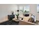 Bright living room with neutral tones, plush seating, and a large window at 370 Geneva St, Aurora, CO 80010