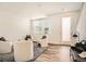 Bright living room featuring hardwood floors, a large window, and stylish, modern furniture at 370 Geneva St, Aurora, CO 80010