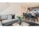 Stylish living room and kitchen space with grey sofa, modern decor, and hardwood flooring at 370 Geneva St, Aurora, CO 80010