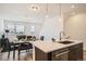 Well-lit open layout with kitchen island, dining set, and living area at 370 Geneva St, Aurora, CO 80010