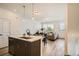 Open floor plan featuring a kitchen island flowing into the dining and living areas at 370 Geneva St, Aurora, CO 80010