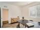 Bright office with a large table, and wood drawers and a window at 370 Geneva St, Aurora, CO 80010
