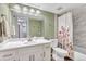 Bright bathroom with a combined shower and tub, updated tile, and a single sink vanity at 9797 E Peakview Ave # C1, Englewood, CO 80111