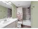 Bathroom with a combined shower and tub, updated tile, and a single sink vanity at 9797 E Peakview Ave # C1, Englewood, CO 80111