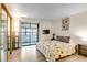 Bedroom with sliding door to a balcony, complemented by a mirrored closet and a mounted television at 9797 E Peakview Ave # C1, Englewood, CO 80111