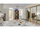 Bedroom with a floral comforter, wood-style flooring, and adjacent bathroom access at 9797 E Peakview Ave # C1, Englewood, CO 80111