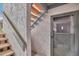Close up view of the entrance to a two-story condominium with wooden stairs and a security door at 9797 E Peakview Ave # C1, Englewood, CO 80111