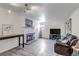 Bright living room features a modern fireplace, light gray floors, and a leather recliner sofa at 9797 E Peakview Ave # C1, Englewood, CO 80111