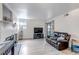 Bright living room features a modern fireplace, light gray floors, and a leather sofa at 9797 E Peakview Ave # C1, Englewood, CO 80111