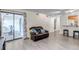 Open-concept living room features light gray floors, large sliding doors, and a comfortable leather loveseat at 9797 E Peakview Ave # C1, Englewood, CO 80111