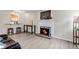 Open living room featuring a fireplace and an adjacent kitchen area with breakfast bar at 9797 E Peakview Ave # C1, Englewood, CO 80111