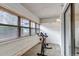 Sunroom featuring multiple windows providing natural light, equipped with an exercise bike at 9797 E Peakview Ave # C1, Englewood, CO 80111