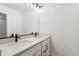 Modern bathroom featuring a double vanity with modern fixtures, quartz countertops, and white cabinetry at 42964 Colonial Trl, Elizabeth, CO 80107