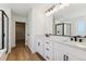 Elegant bathroom features a double vanity, modern fixtures, and a glass-enclosed shower with marble accents at 42964 Colonial Trl, Elizabeth, CO 80107