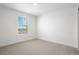 This is a bright bedroom featuring neutral carpet and a window with blinds providing natural light at 42964 Colonial Trl, Elizabeth, CO 80107