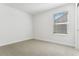 Bright bedroom with neutral carpet and a window providing natural light at 42964 Colonial Trl, Elizabeth, CO 80107