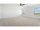 Spacious bedroom with neutral carpet, ceiling fan, and windows providing ample natural light at 42964 Colonial Trl, Elizabeth, CO 80107