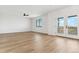 Light-filled bedroom with hardwood floors, a ceiling fan, a large window, and access to a balcony at 42964 Colonial Trl, Elizabeth, CO 80107