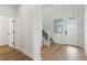 Bright entryway with hardwood floors, white trim, a staircase, and a front door with sidelights at 42964 Colonial Trl, Elizabeth, CO 80107
