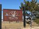 Entrance sign for Spring Valley Golf Club and the green hills on the golf course are visible at 42964 Colonial Trl, Elizabeth, CO 80107