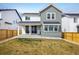 The backyard of this inviting two-story home features a covered patio, sliding doors and fenced-in yard at 16568 W 92Nd Pl, Arvada, CO 80007