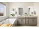 Bright bathroom featuring double sinks, soaking tub, and modern finishes for a spa-like experience at 16568 W 92Nd Pl, Arvada, CO 80007