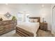 Cozy bedroom with a light-colored bed set between matching nightstands and a large dresser against the wall at 16568 W 92Nd Pl, Arvada, CO 80007
