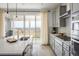 Bright kitchen with quartz countertops, stainless appliances, and a sliding glass door with beautiful views at 16568 W 92Nd Pl, Arvada, CO 80007