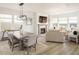 Open-concept living and dining area with modern lighting, fireplace, and large windows with great views at 16568 W 92Nd Pl, Arvada, CO 80007