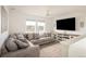 Cozy living room with plush sectional sofa, ceiling fan, and large TV for entertainment at 16568 W 92Nd Pl, Arvada, CO 80007