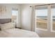 Main bedroom with view from multiple windows, light walls, and neutral decor at 16568 W 92Nd Pl, Arvada, CO 80007