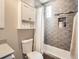 Modern bathroom featuring tile surround tub and shower, and built-in shelving at 1246 Xavier St, Denver, CO 80204