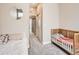 A bright bedroom featuring two beds and a well-lit hallway at 1246 Xavier St, Denver, CO 80204