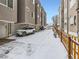 Exterior view showing parking area beneath modern townhomes in a snowy landscape at 1246 Xavier St, Denver, CO 80204