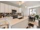 Bright modern kitchen with a breakfast bar, white cabinets, stainless appliances and decorative backsplash at 1246 Xavier St, Denver, CO 80204