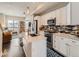 Stylish open kitchen featuring modern appliances, an island with sink, and a seamless flow to the living area at 1246 Xavier St, Denver, CO 80204