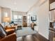 Bright living room featuring a large window, hardwood floors, a stylish rug, and modern furniture at 1246 Xavier St, Denver, CO 80204